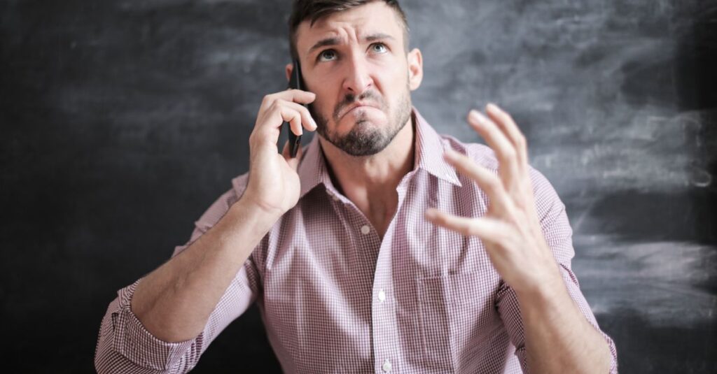man worried looking phone