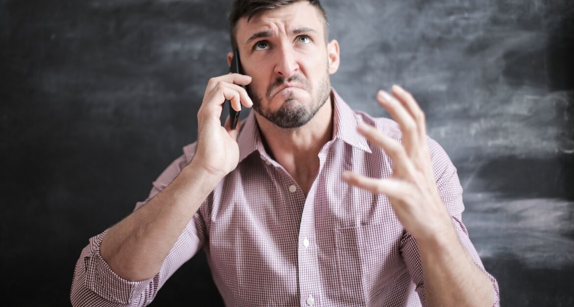 man worried looking phone